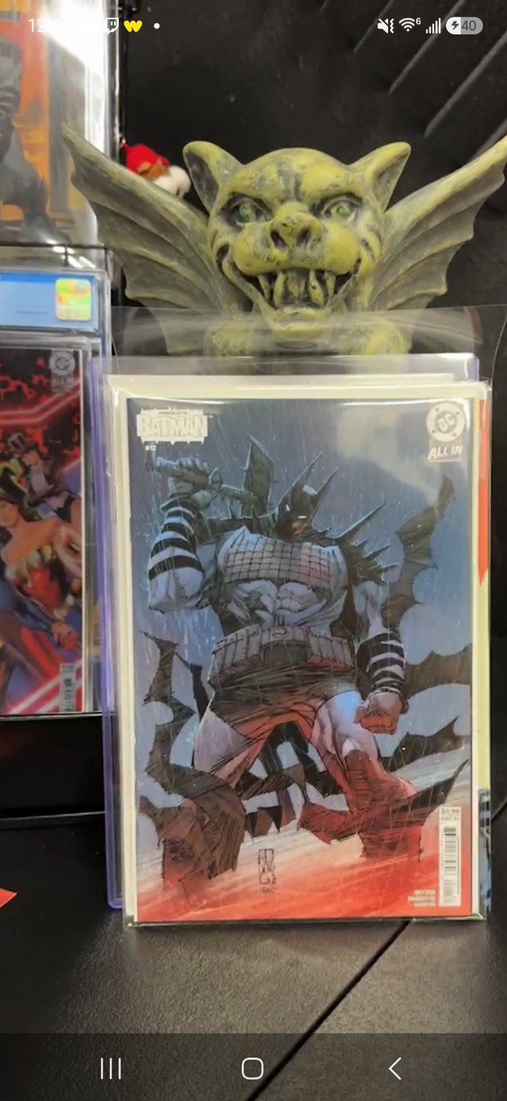 Inside the Absolute Comics shop — longboxes, framed covers, dim warm light